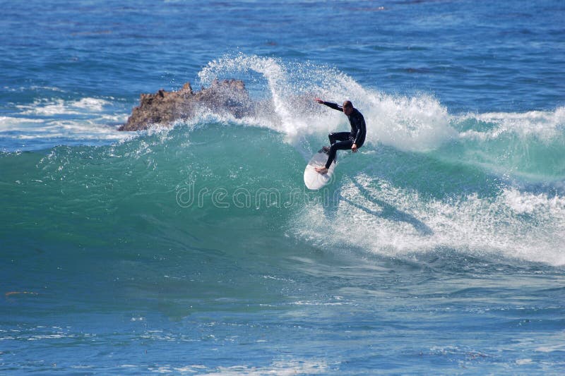 Board surfer riding in a wave at Laguna Beach, CA.