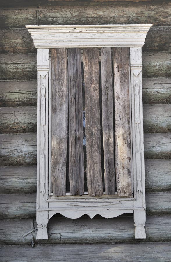 Boarded-up window of an old country wooden house