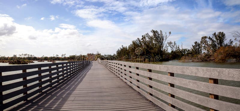 Boardwalk goes through the swamp at Lakes Park and shows Hurricane Irma damage stock photos Boardwalk goes through the swamp at Lakes Park and shows Hurricane Irma damage stock photos