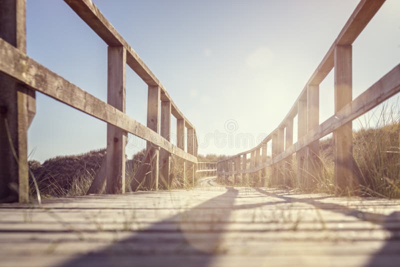 Boardwalk leading to the beach over sand dunes