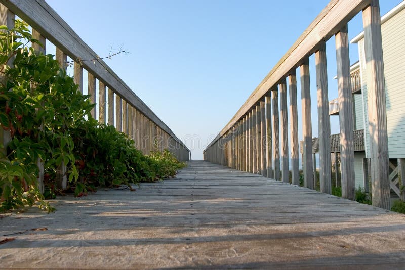 Low angle view of a boardwalk from a beachhouse to the beach on Emerald Isle, North Caroloina. Boardwalk rail stock images, royalty-free photos and pictures