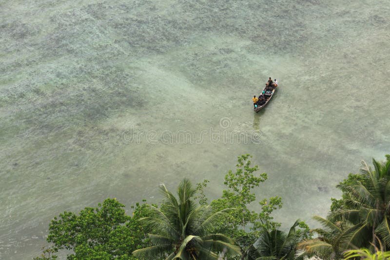 Boat approaching shore in tropical sea destination Pasumpahan island stock photo Boat approaching shore in tropical sea destination Pasumpahan island stock photo