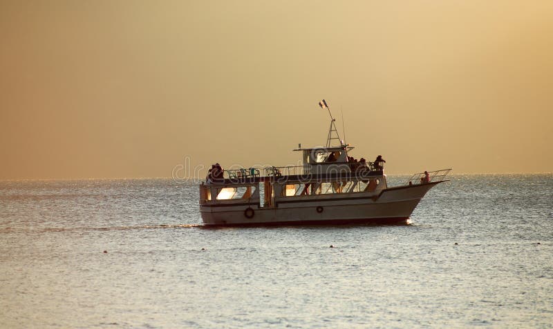 Moving boat in the Guatemalan Atitlan Lake at sunset. Moving boat in the Guatemalan Atitlan Lake at sunset.