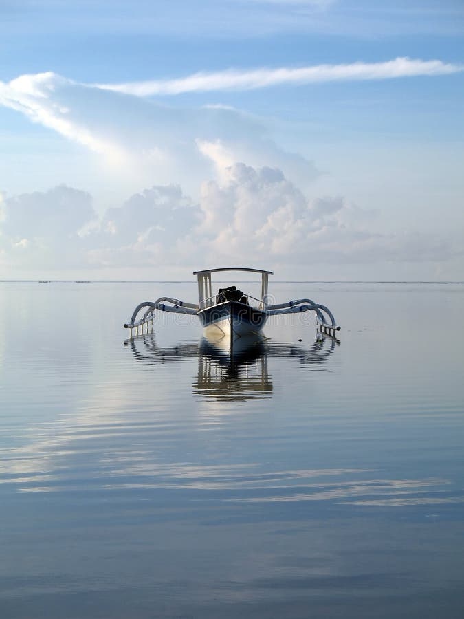 Fishing boat off the shore of Sanur in Bali. Serene beach atmosphere stock images, royalty-free photos and pictures