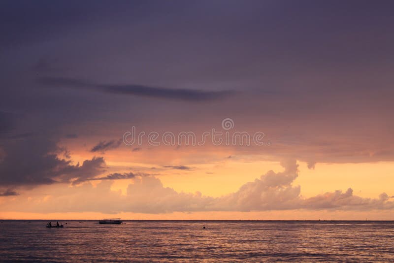 Boat on colored sea and ocean at sunset on Lovina beach, Bali Indonesia royalty free stock photography Boat on colored sea and ocean at sunset on Lovina beach, Bali Indonesia royalty free stock photography