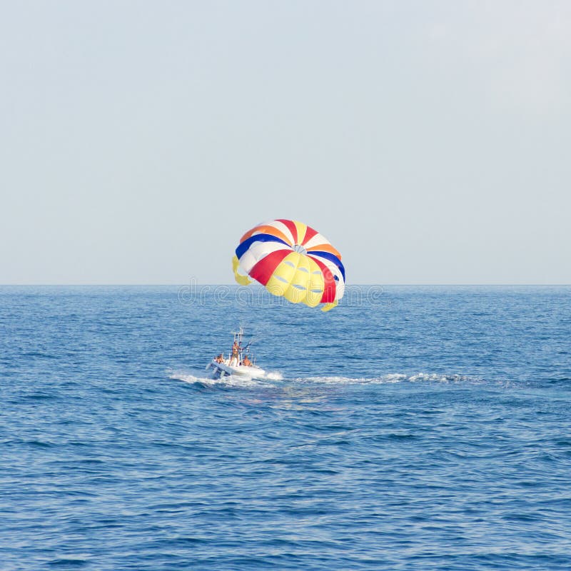 Boat With Colorful Parachute Floating In Sea Stock Image Image of
