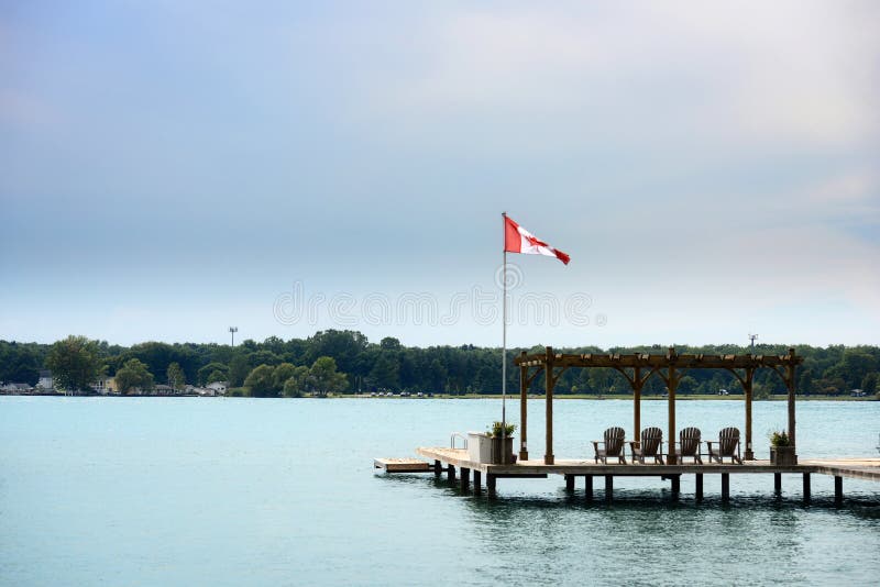Boat Dock on a River with Canadian Flag Stock Photo Image of cottage, america 259055468