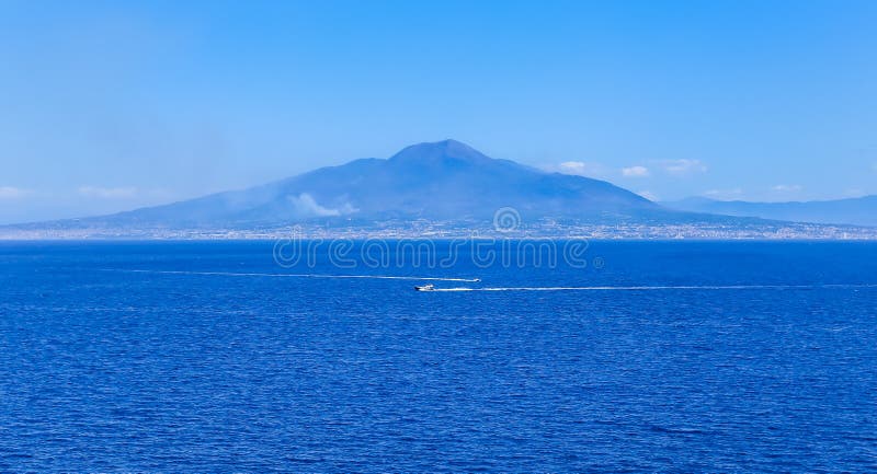 Boat in front of Mount Vesuvius in Bay of Naples at Sorrento resort town