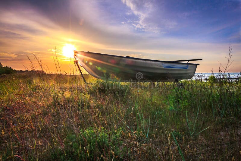 Boat in grass with sunrise