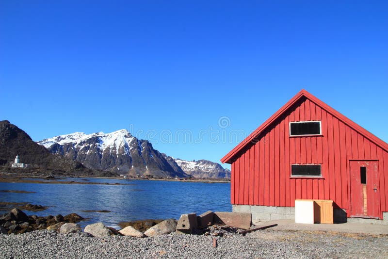 Boat house, church and snowy mounts