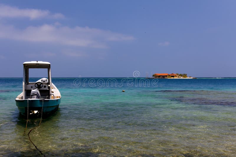 Boat and Island in the calm Caribbean sea