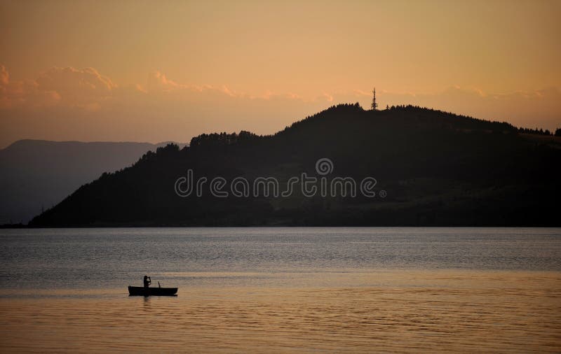 Boat on lake during sunset