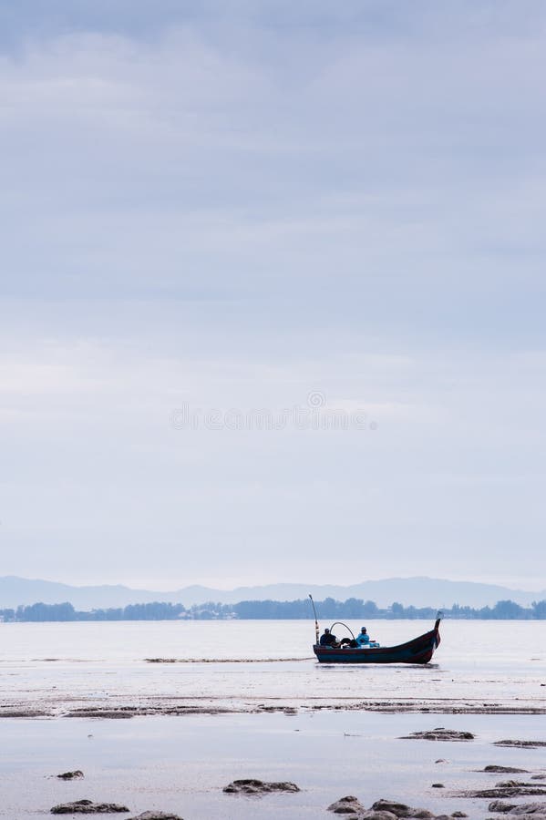 Boat near beach on low tide