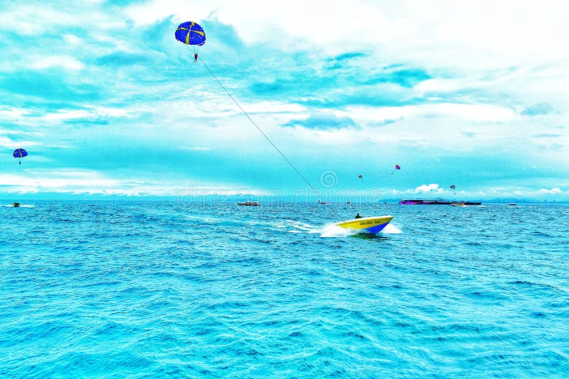 A boat with a parachute editorial photo. Image of beach 126084016