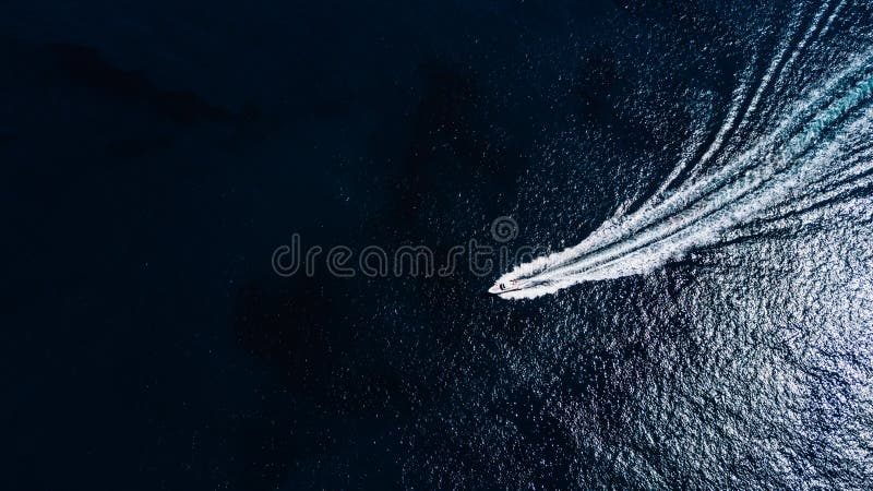 Sea Boat sealing in ocean view from above. Aerial view of moving boat or yacht in sea.