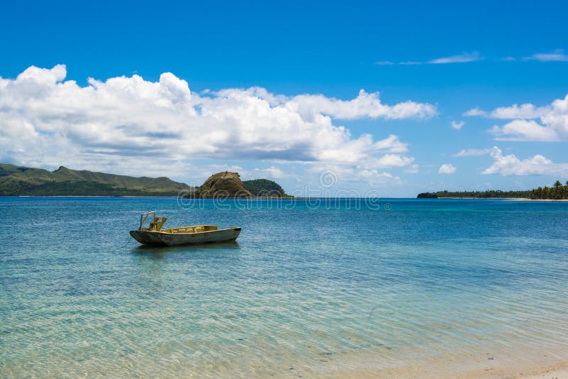 Wooden boat on clear water of Pacific Ocean, beautiful seascape