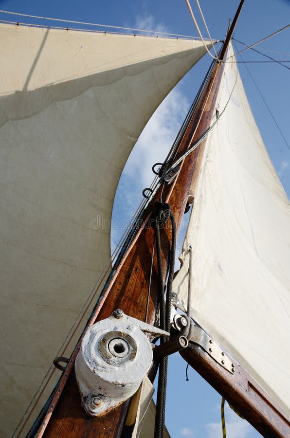 Boat standing and running rigging - mainsail,backstay,pulley blocks,winch,rope and guy lines. Boat standing and running rigging - mainsail,backstay,pulley blocks,winch,rope and guy lines