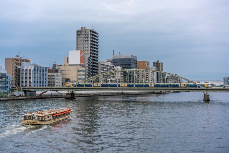 Sumida-ku, Tokyo - July 28, 2017: A boat in Sumida river and Yanagi-bashi bridge from Ryogoku-bashi Bridge