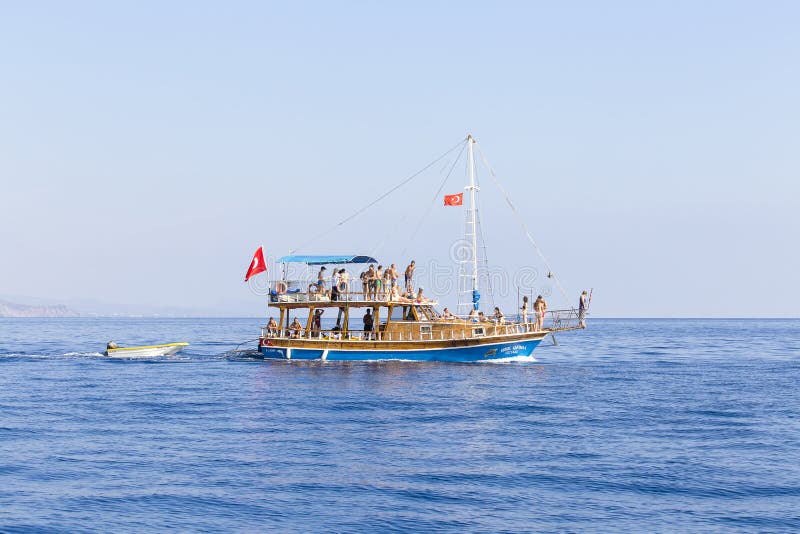 Boat with tourists returns from a cruise to the Kemer beach, Turkey. The Kemer is very popular among tourists. stock photos Boat with tourists returns from a cruise to the Kemer beach, Turkey. The Kemer is very popular among tourists. stock photos