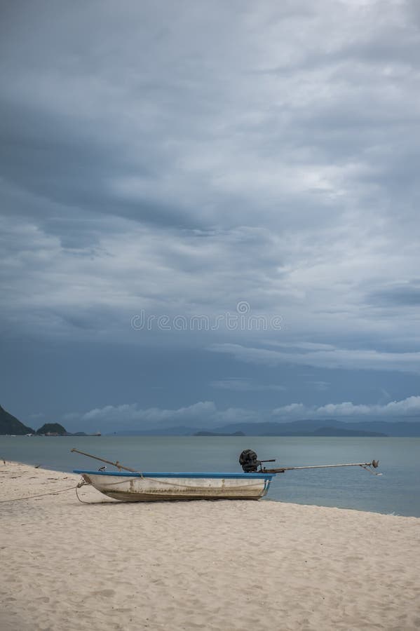 Boat in the tropical sea under gloomy dramatic sky. stock images
