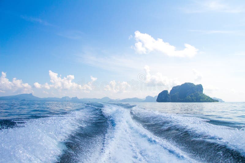 Boat wake prop wash on blue ocean sea