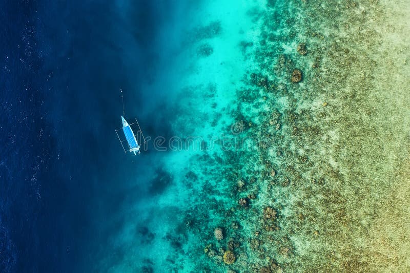Boat on the water surface from top view. Azure water background from top view. Summer seascape from air. royalty free stock photography
