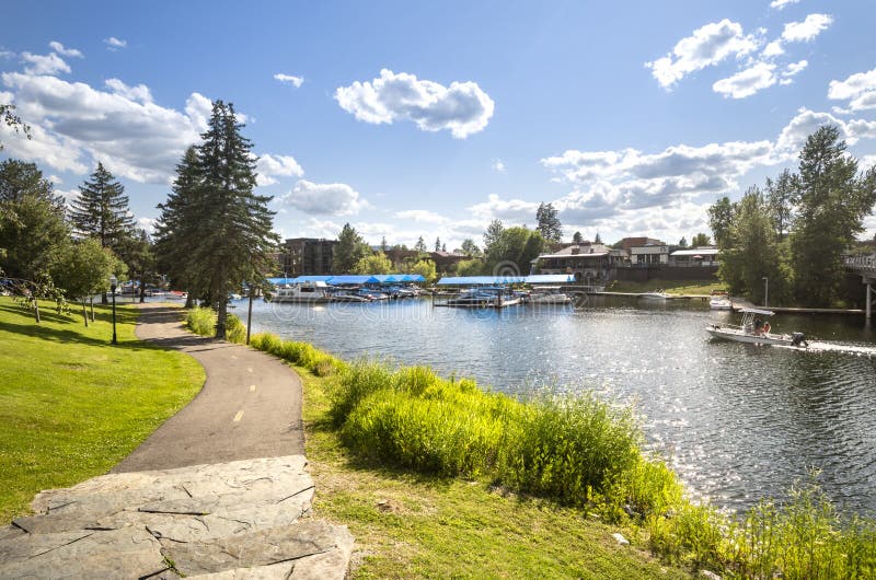 Boats dock along Sand Creek river along Lake Pend Oreille in the downtown area of Sandpoint, Idaho, on a sunny summer day royalty free stock photography Boats dock along Sand Creek river along Lake Pend Oreille in the downtown area of Sandpoint, Idaho, on a sunny summer day royalty free stock photography