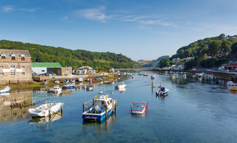 Boats on Looe river Cornwall England blue sea and sky