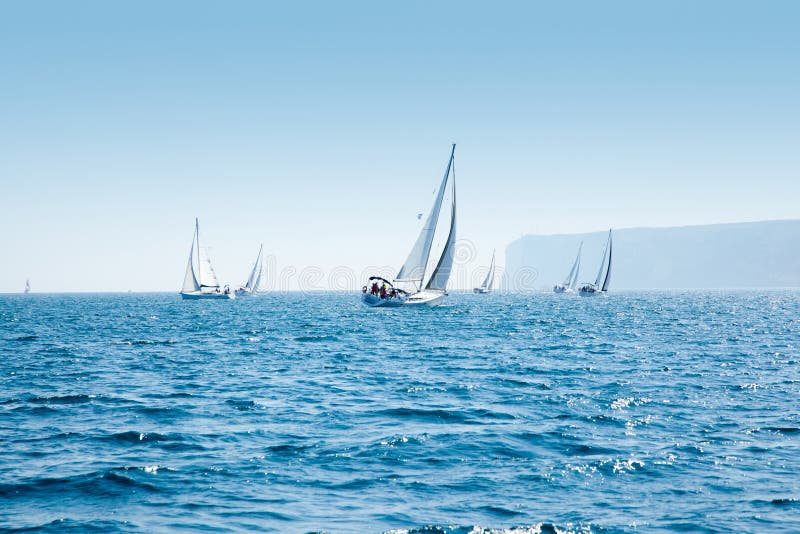 Boats sail regatta with sailboats in mediterranean