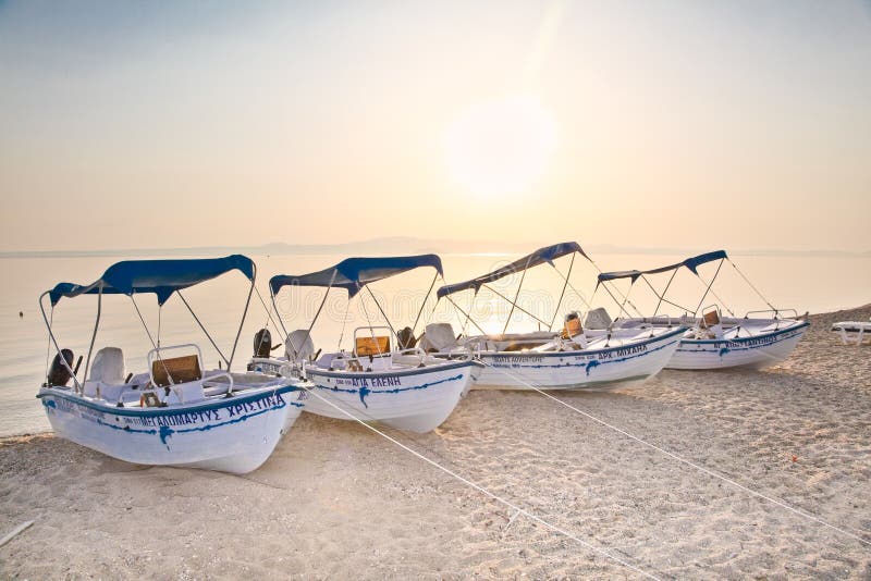 Boats on sandy beach in Polychrono, Kasandra peninsula , Greece.