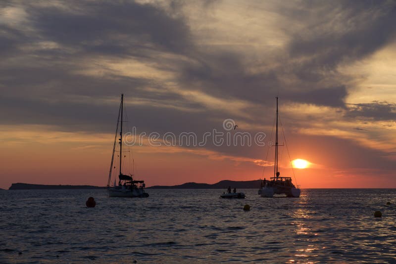 Boats in the sea in front of CafÃ© del Mar at the Spanish Island Ibiza in the mediterranean sea in Europe. CafÃ© del Mar is a famous spot on the island and the best place for sunset. Boats in the sea in front of CafÃ© del Mar at the Spanish Island Ibiza in the mediterranean sea in Europe. CafÃ© del Mar is a famous spot on the island and the best place for sunset.