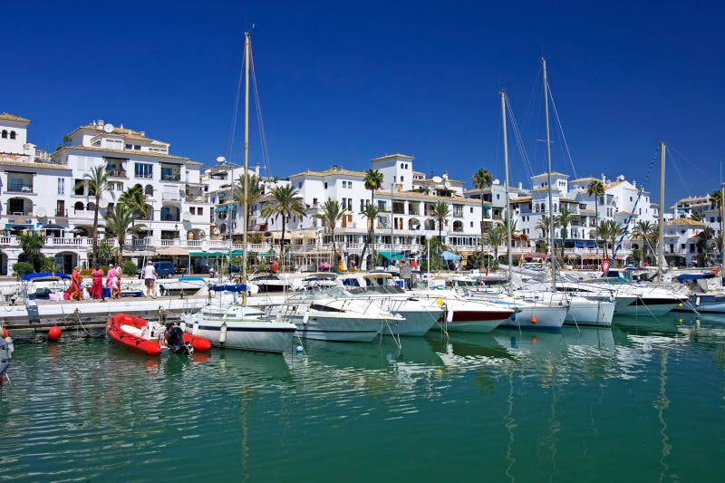 Beautiful white luxury boats and yachts moored in Duquesa port in Spain on the Costa del Sol