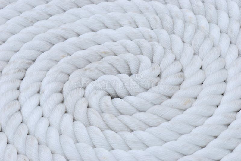 A coil of white mooring line rope for ship anchor. A coil of white mooring line rope for ship anchor.