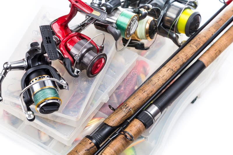 Different fishing reels and rods on storage boxes with fishing baits and lures. Different fishing reels and rods on storage boxes with fishing baits and lures