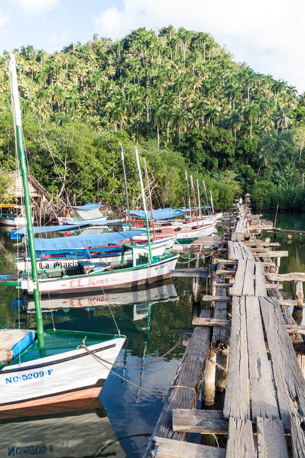 BOCA DE MIEL, CUBA - FEB 4, 2016: Fishing boats anchored at Rio Miel river mouth near Baracoa, Cu stock photos BOCA DE MIEL, CUBA - FEB 4, 2016: Fishing boats anchored at Rio Miel river mouth near Baracoa, Cu stock photos