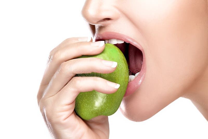 Closeup of beautiful healthy mouth biting a juicy and acid green apple. Closeup portrait isolated on white background. Closeup of beautiful healthy mouth biting a juicy and acid green apple. Closeup portrait isolated on white background