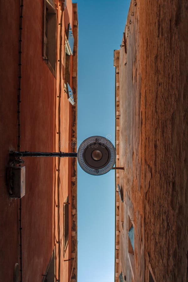 Abstract conceptual image. Bottom view of Traditional street lamp at an old Venetian house in the middle of the day with a blue sky. Abstract conceptual image. Bottom view of Traditional street lamp at an old Venetian house in the middle of the day with a blue sky