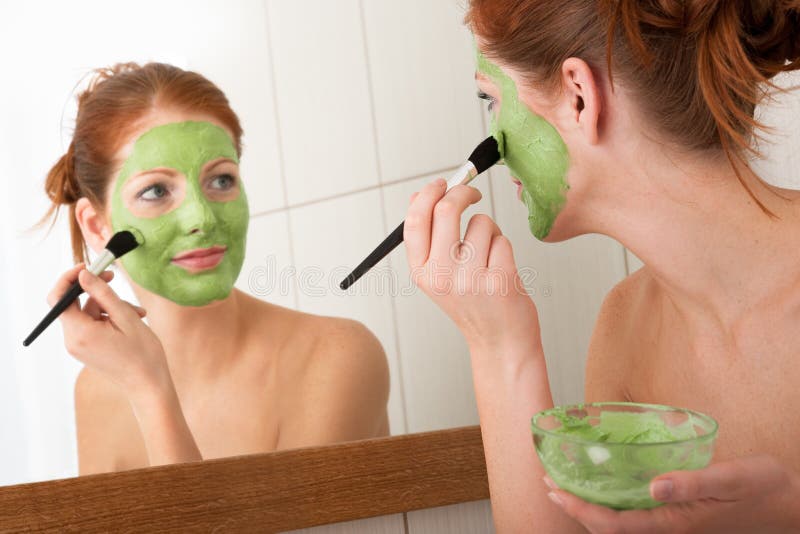 Body care - Young woman apply facial mask stock photo Body care - Young woman apply facial mask stock photo