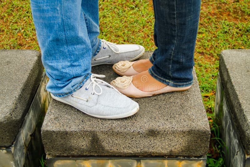 A Couple with Shoes Facing Each Other at the Park. Stock Image - Image ...