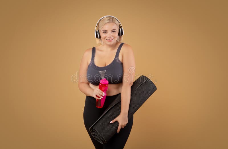 Sport Curvy Black Woman Listening Music with Headphones - Focus on