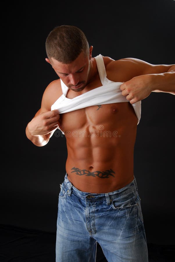 A muscular bodybuilder changing his shirt