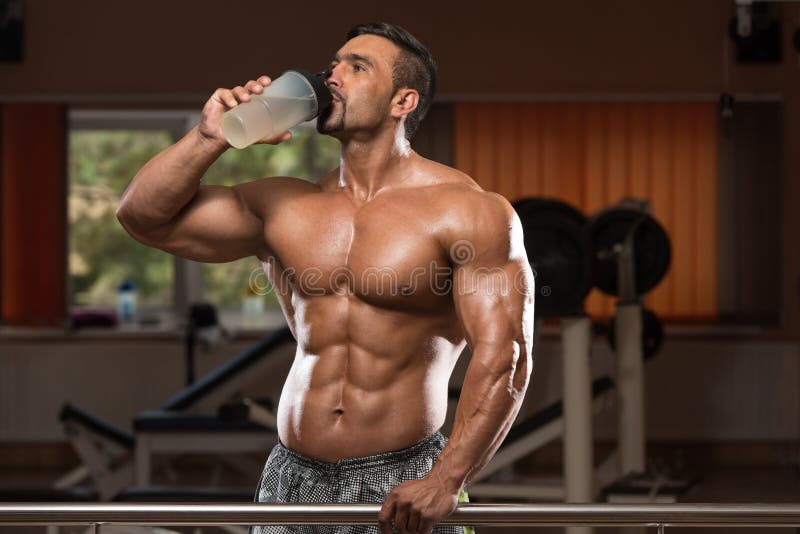 Muscular Man Drinking A Water Bottle. Muscular Man Drinking A Water Bottle