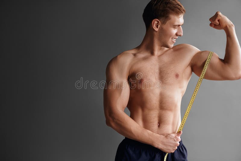 Bodybuilder Measuring Muscle Stock Photo - Image of macho, muscular:  100967346