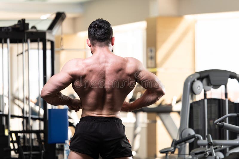 Bodybuilder Performing Rear Lat Spread Pose Stock Image - Image of ...