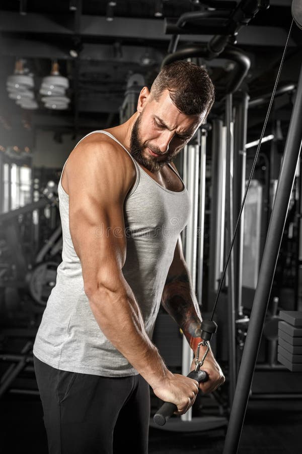 Bodybuilding. Bearded Man Standing Doingcable Straight Arm Pulldown at Gym Concentrated Stock