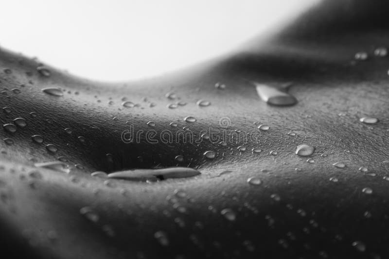 Bodyscape of a nude woman with wet stomach and back lighting art