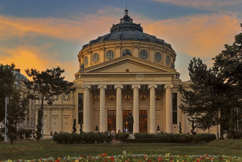 The Romanian Athenaeum (Romanian: Ateneul Român) is a concert hall in the center of Bucharest, Romania and a landmark of the Romanian capital city. Opened in 1888, the ornate, domed, circular building is the citys main concert hall and home of the George Enescu Philharmonic and of the George Enescu annual international music festival, on June 27, 2015 in Bucharest, Romania. The Romanian Athenaeum (Romanian: Ateneul Român) is a concert hall in the center of Bucharest, Romania and a landmark of the Romanian capital city. Opened in 1888, the ornate, domed, circular building is the citys main concert hall and home of the George Enescu Philharmonic and of the George Enescu annual international music festival, on June 27, 2015 in Bucharest, Romania