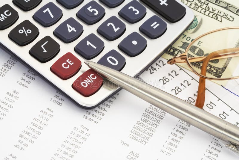 Calculator, glasses, dollar and pen on the background of the financial statements. Calculator, glasses, dollar and pen on the background of the financial statements