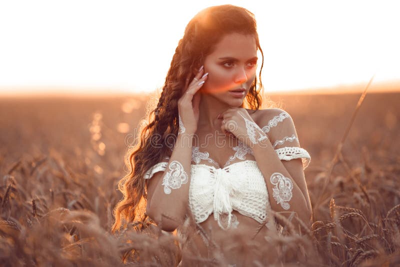 Boho Chic Style. Portrait of Bohemian Girl with White Art Posing Over Wheat  Field Enjoying at Sunset. Outdoors Photo Stock Photo - Image of bridal,  fashion: 152225262