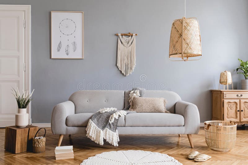 Boho living room with grey sofa and natural accessories. Cosy home decor.